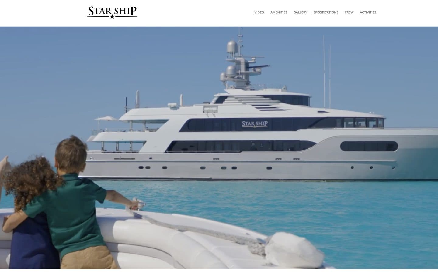 The Starship website homepage: the yacht at anchor in turquoise water, seen from the bow of a tender, beneath a menu of Video, Amenities, Gallery, Specifications, Crew and Activities
